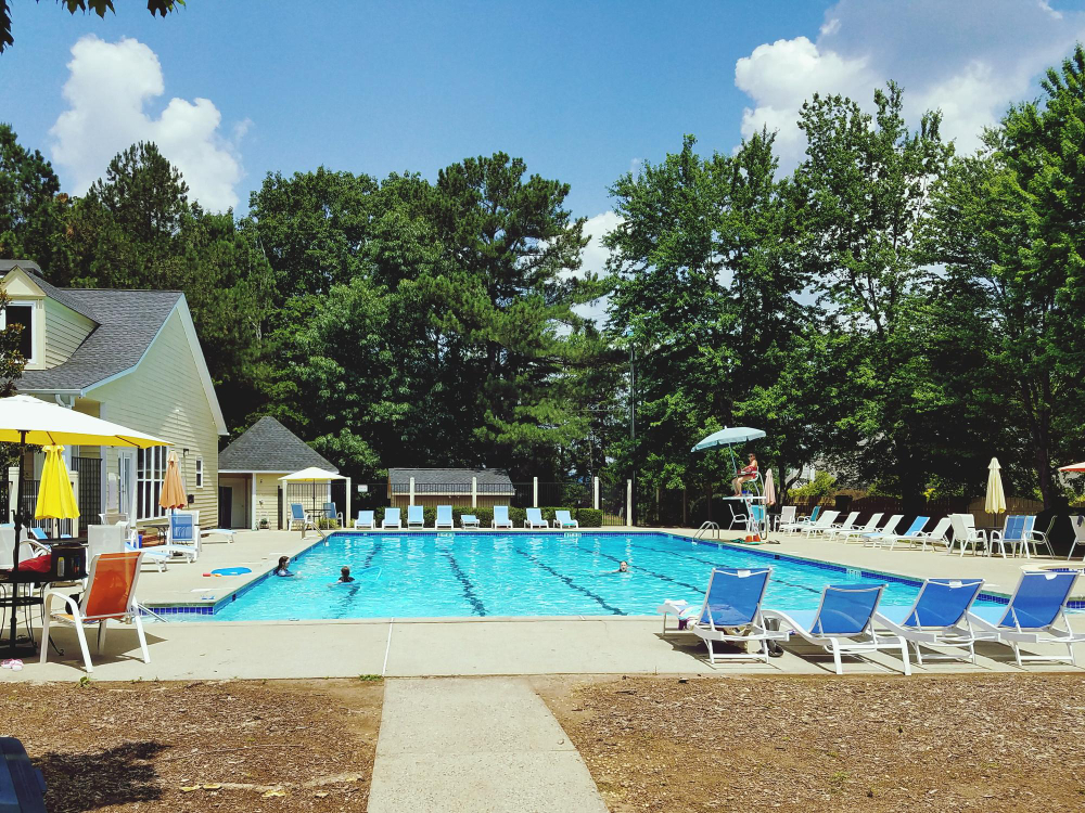 Guests enjoying campground amenities like pool and playground